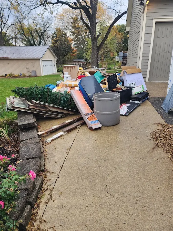 Dumpster being loaded with debris for Estate Cleanout Dumpster Rental in Fultondale